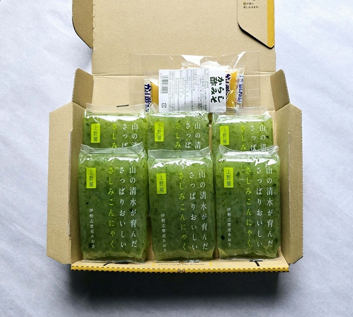 開封された箱に詰められた緑色のパッケージ